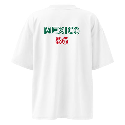 White short-sleeve t-shirt shown from the back, featuring 'MEXICO' printed in green and '86' printed in red on the upper back.